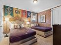 Themed bedroom with two beds, brick accent wall, and themed decor at 733 Desert Mountain Ct, Reunion, FL 34747