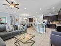Open-concept living room featuring tile floors and an adjoining eat-in kitchen at 733 Desert Mountain Ct, Reunion, FL 34747