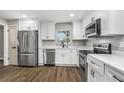 Modern kitchen featuring white cabinets and stainless steel appliances at 8607 Tarragon Dr, Orlando, FL 32825