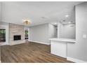 Bright living room with hardwood floors and a stone fireplace at 8607 Tarragon Dr, Orlando, FL 32825