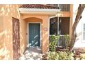 Condo entrance with teal door, showcasing a well-maintained building exterior at 12414 Baleria Cv # 108, Orlando, FL 32837