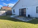 House backyard with patio and grassy area at 136 Pinewood Cir, Kissimmee, FL 34743