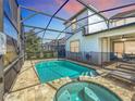 Relaxing screened-in pool and spa with a patio area at 1812 Sandy Park Trl, Kissimmee, FL 34747