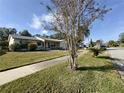 House with mature trees and a quiet street at 219 Macon Way, St Cloud, FL 34769