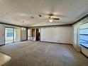 Spacious living area with carpeted floors and a ceiling fan at 219 Macon Way, St Cloud, FL 34769