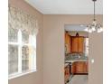 Bright dining area with window and view into the kitchen at 223 Largovista Dr, Oakland, FL 34787