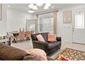 Bright, open-concept living area with tile floors, modern furnishings, and natural light at 2276 Centerra Loop, Kissimmee, FL 34741