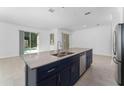 Spacious kitchen with island, stainless steel appliances, and dark cabinets at 2381 Reading Trl, Kissimmee, FL 34746