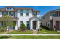 Beautiful two-story townhouse with manicured lawn and charming front entrance, creating a welcoming curb appeal at 2449 Varenna Loop, Kissimmee, FL 34741