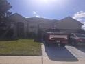 House exterior with a driveway and landscaping at 2889 Paige Dr, Kissimmee, FL 34741