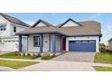 Craftsman style home with red door, blue garage, and a well manicured lawn at 3055 Prospect Trl, St Cloud, FL 34771