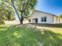 Spacious backyard with a mature tree providing shade and a white fence surrounding the property at 438 Jay Ct, Kissimmee, FL 34759