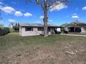 Cozy single-story home with green lawn and a mature tree at 589 Duncan E Cir, Auburndale, FL 33823