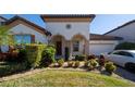 Two-story home with attractive landscaping and a paved driveway at 9067 Arbors Edge Trl, Windermere, FL 34786
