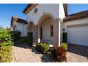 Home exterior showcasing a covered entry and a brick walkway at 9067 Arbors Edge Trl, Windermere, FL 34786