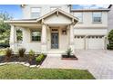 Inviting front porch featuring a gray front door, white railing, and manicured landscaping at 9786 Lake District Ln, Orlando, FL 32832