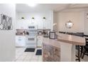 Bright kitchen with white cabinets, granite countertops, and stainless steel appliances at 1118 Park Ridge Cir, Kissimmee, FL 34746