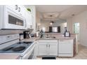 Clean, well-lit kitchen featuring white cabinets and modern appliances at 1118 Park Ridge Cir, Kissimmee, FL 34746