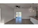Living room area featuring ceiling fan, recessed lighting, granite countertop and sliding glass doors at 1315 Congo Dr, Kissimmee, FL 34759