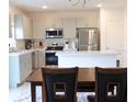 Eat-in kitchen with stainless steel appliances and an island at 196 Albany Dr, Kissimmee, FL 34759