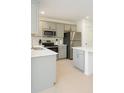 Modern kitchen with stainless steel appliances, gray cabinets, and a bright, clean design at 196 Albany Dr, Kissimmee, FL 34759
