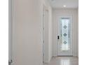 Bright entryway with tile flooring and a door with stained glass at 2124 Live Oak Lake Rd, St Cloud, FL 34771