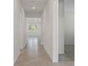 Long hallway with tile floors and neutral-toned walls at 2124 Live Oak Lake Rd, St Cloud, FL 34771