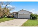 Front view of a single-story house with a two-car garage at 2302 Aberdeen Ct, Kissimmee, FL 34743