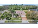 House with a landscaped yard and a brick driveway, aerial view at 2404 Huron Cir, Kissimmee, FL 34746