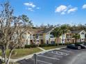 Condo building exterior, showing multiple units and parking at 2452 Sweetwater Club Cir # 27, Kissimmee, FL 34746