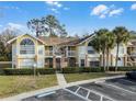 Condo building exterior, showing multiple units and landscaping at 2452 Sweetwater Club Cir # 27, Kissimmee, FL 34746