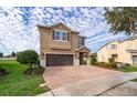 Two-story house with brown brick driveway and landscaping at 250 Pendant Ct, Kissimmee, FL 34747