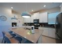 Bright kitchen features white cabinets, stainless steel appliances, and a large center island at 2797 Bookmark Dr, Kissimmee, FL 34746
