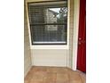Condo exterior with tiled patio and door at 3036 Parkway Blvd # 106, Kissimmee, FL 34747