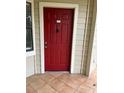 Red front door entrance to condo unit at 3036 Parkway Blvd # 106, Kissimmee, FL 34747