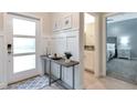 Bright entryway with console table, view of bathroom and bedroom at 4349 Quote St, Kissimmee, FL 34746