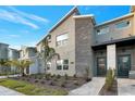 Modern two-story townhome with stone accents and landscaped front yard at 4349 Quote St, Kissimmee, FL 34746
