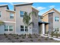 Modern two-story townhome with stone accents and landscaped front yard at 4349 Quote St, Kissimmee, FL 34746