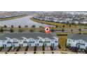 Townhome community with lake and surrounding houses at 4806 Tribute Trl, Kissimmee, FL 34746