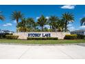 Storey Lake community entrance with stone signage and palm trees at 4806 Tribute Trl, Kissimmee, FL 34746