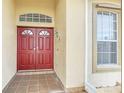 Double red doors with a tiled entryway at 4878 Zion Dr, St Cloud, FL 34772