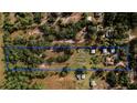 Wide aerial view highlighting property boundaries and buildings at 4999 Disston Dr, St Cloud, FL 34771