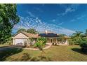 Charming single-story home with solar panels and a landscaped yard at 4999 Disston Dr, St Cloud, FL 34771