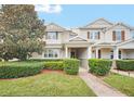 Two-story townhome with a landscaped front yard and brick walkway at 6530 Stoller Ave, Windermere, FL 34786