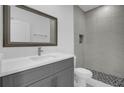 Modern bathroom with gray vanity and tile shower at 661 Lincoln St, Kissimmee, FL 34741