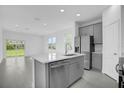 Modern kitchen with gray cabinets and island at 661 Lincoln St, Kissimmee, FL 34741