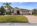 Single-story house with stone accents and a two-car garage at 672 San Joaquin Rd, Kissimmee, FL 34759