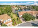 Aerial view of community showing townhome and lake at 8318 Quimby Cir, Davenport, FL 33896