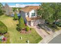 Two-story townhome with a view of the backyard and community lake at 8318 Quimby Cir, Davenport, FL 33896