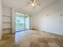 Bright bedroom with tile floors and access to a private balcony at 8803 Dunes Ct # 306, Kissimmee, FL 34747